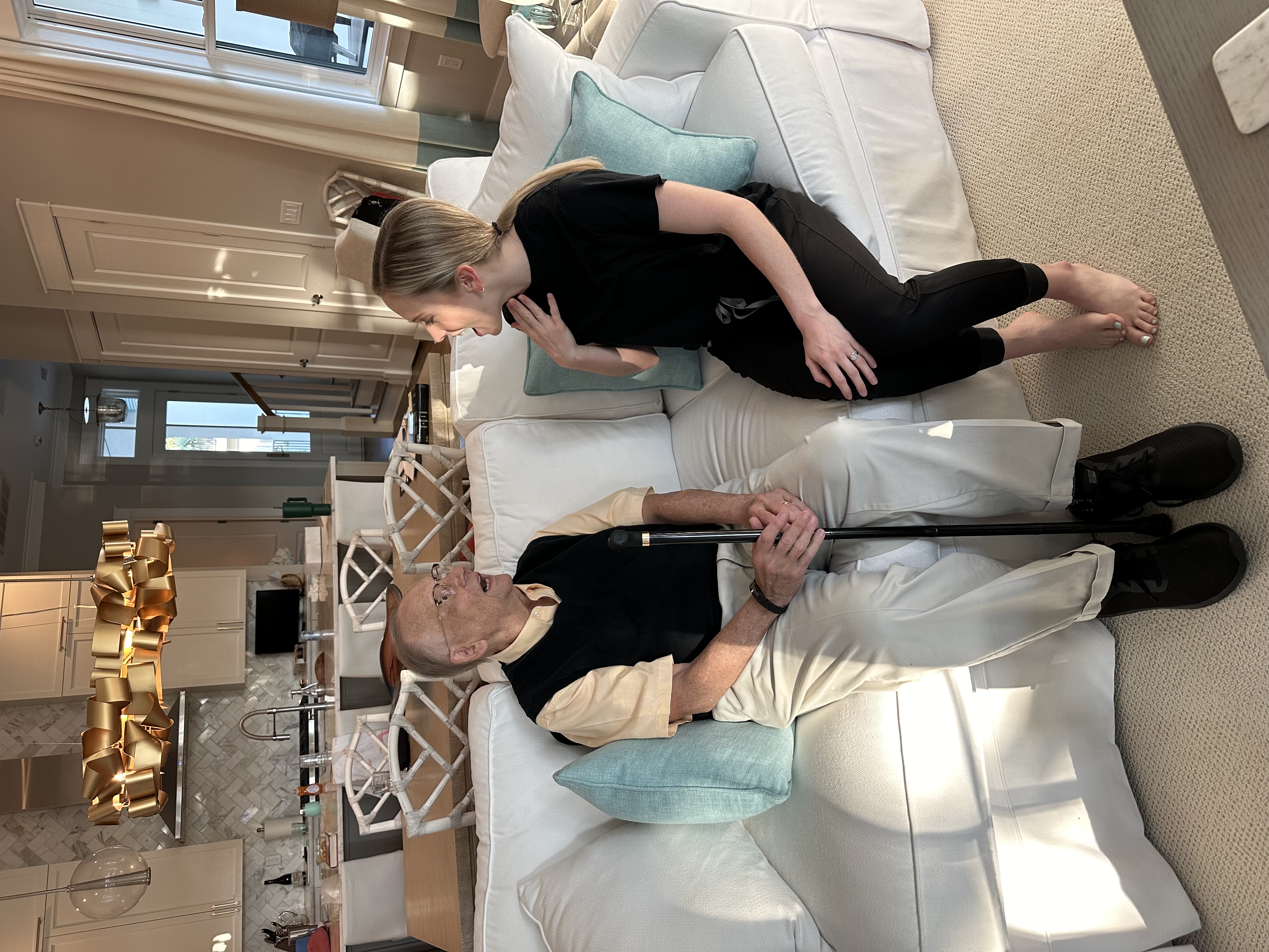 Speech therapist working with an adult client at home