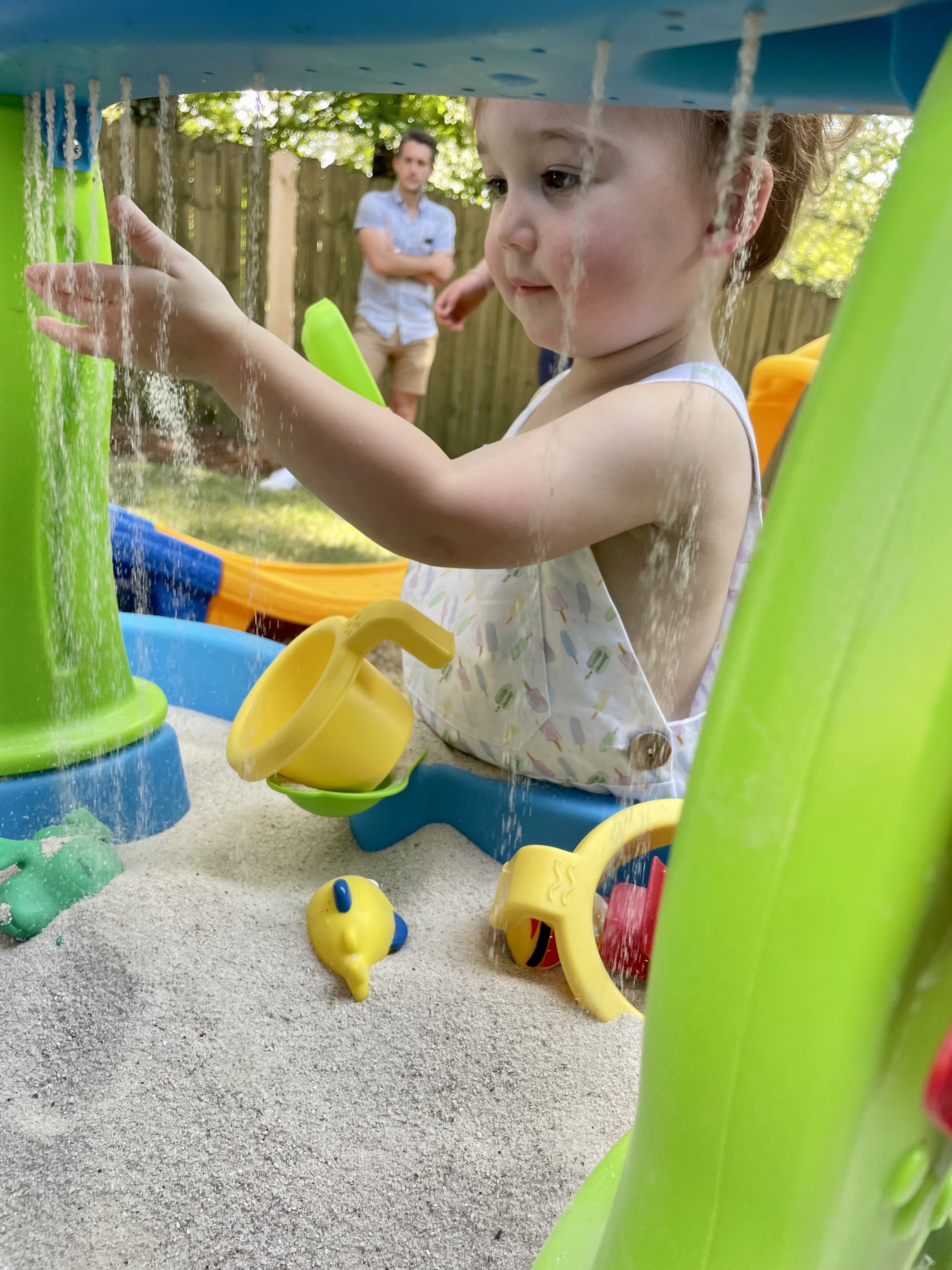 Child playing in sand during a playful therapy activity