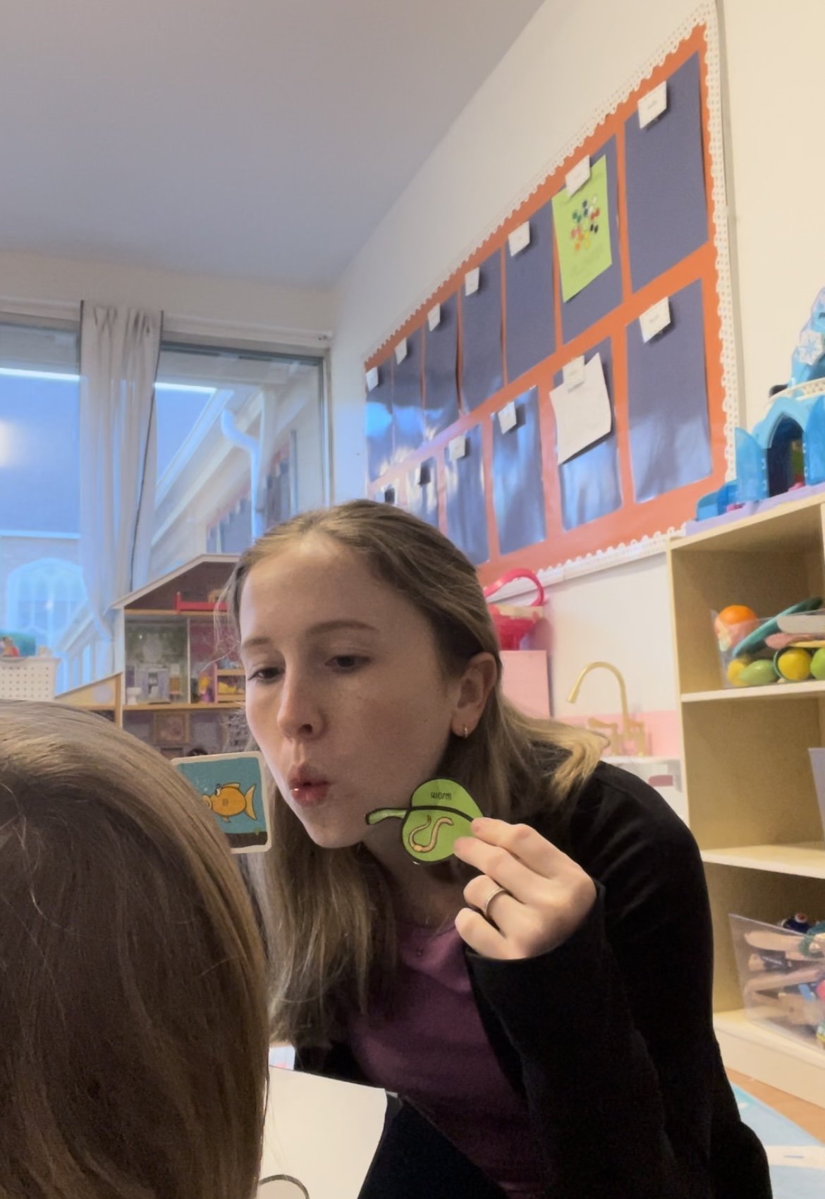 Pediatric speech therapist working on articulation with a child